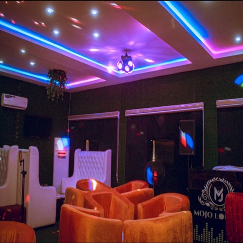 The Mojo lounge club with coloured ceiling lights and velvet seating
