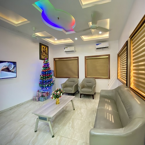 The reception lounge with leather sofas and a lit feature ceiling