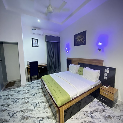 Super Deluxe room with a king bed, work desk and marble-effect floor